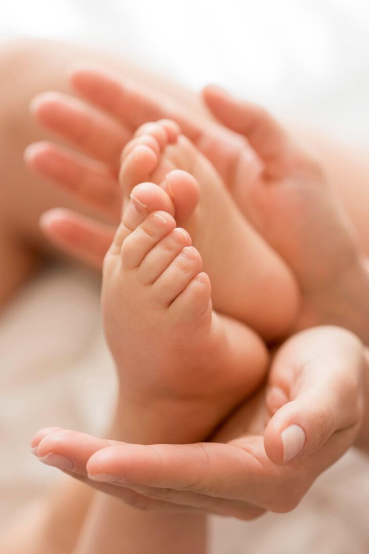 Close-up of a mom holding her baby's feet with her hands
